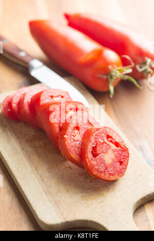 Sliced San marzano tomatoes on cutting board. Stock Photo