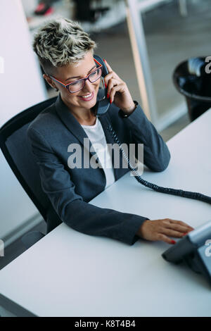 Portrait of busy female architect talking on phone Stock Photo