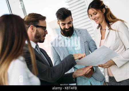 Team of architects working on construction plans Stock Photo