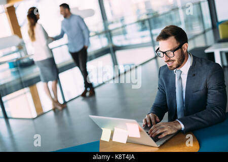 Young handsome architect working on laptop in office Stock Photo