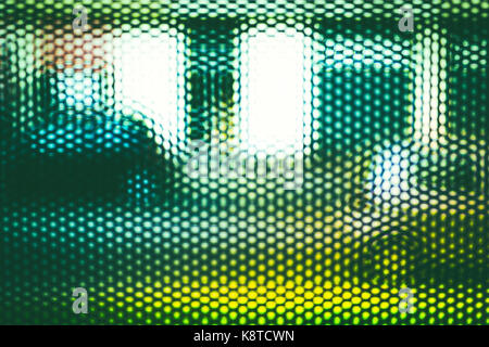 passing street cars seen through grid Stock Photo