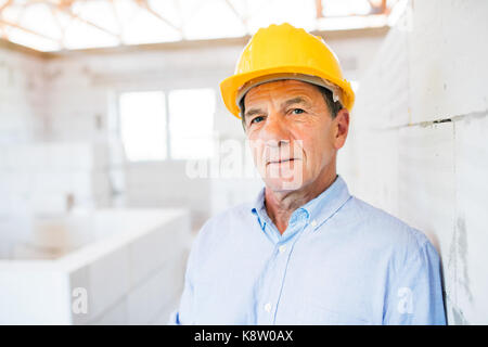 Senior architect or civil engineer on the construction site. Stock Photo