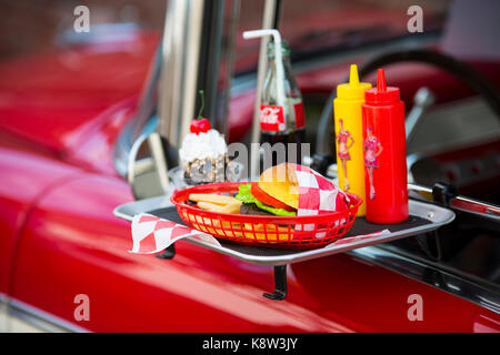 Fast food menu on a tray on door of Cadillilac classic car. Credit: Christian Lademann Stock Photo