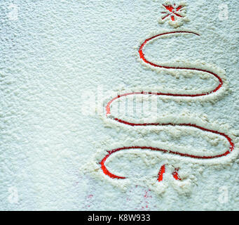 Christmas Background of Tree Drawing in Flour that looks like snow or ice. Stock Photo