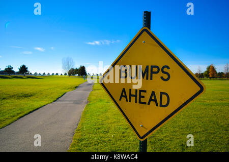 Bumps Ahead Sign Near Paved Path Stock Photo