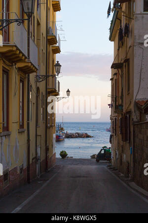 Sorrento, Italy, September 16 2017. Marina Grande in Sorrento, Italy is glimpsed at dawn from between traditional buildings. © Paul Davey Stock Photo