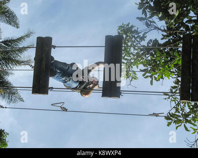 A girl climbing 12 feet over ground in El Salado Ecological Park Stock Photo