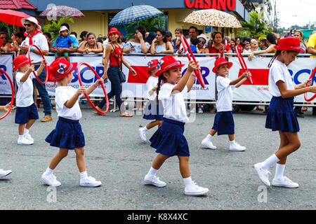 Group of girls with hula hoops marching in the 2017 Independence Day parade in Quepos, Costa Rica. Stock Photo