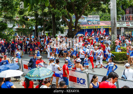 Crowds gather to watch the participants of the 2017 Independence Day Parade in Quepos, Costa Rica walk by. Stock Photo