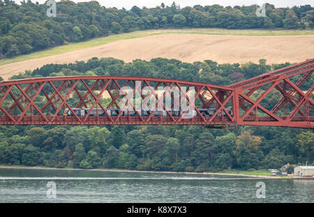 View of a ScotRail train on cantilever Forth Rail Bridge over Firth of Forth, Scotland, UK Stock Photo
