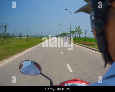 Hue, Vietnam - September 13 2017: Close up of unidentified man riding a motorcycle in the street in the city of Hue, Vietnam Stock Photo