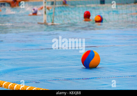 A water polo ball floating on the water in a pool during the game Stock Photo