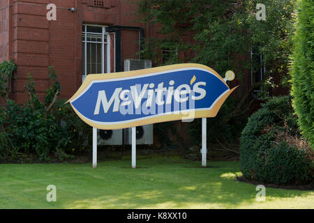 A sign outside the McVitie's factory on the border of Levenshulme and Heaton Chapel in Manchester featuring the company logo (Editorial use only). Stock Photo