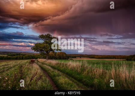 Hertfordshire countryside during a passing rain shower with rainbow, Woodhall Estate, Near Bramfield Stock Photo