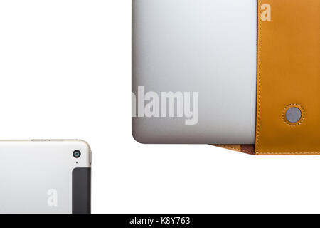 Tablet and Portable computer in a leather cover case on white background Stock Photo