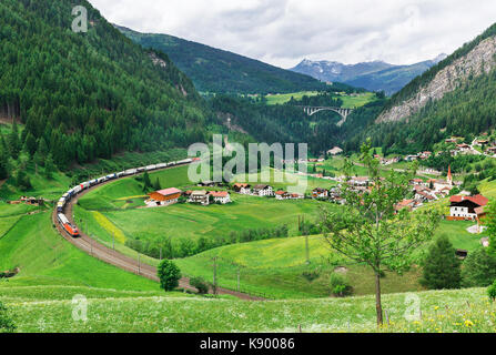 train on a background of village in the Austrian Alps Stock Photo