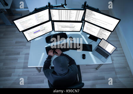 High angle view of hacker using computers to steal data Stock Photo