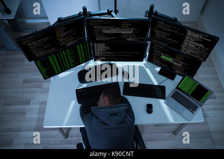 High angle view of tired hacker sleeping near computers at night Stock Photo