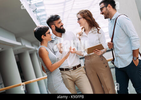 Group of young perspective businesspeople having discussion Stock Photo