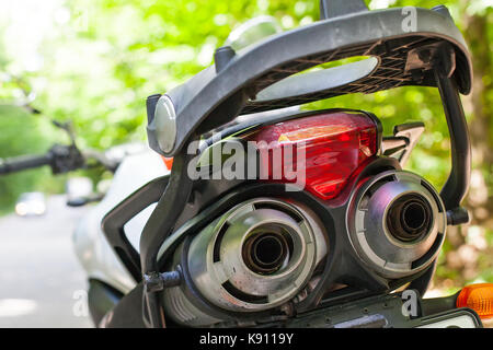 Picture of a motorcycle parked on a country road in a forest Stock ...