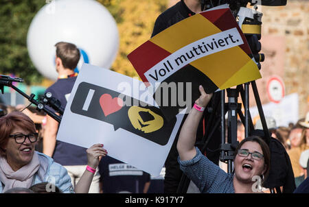 Giessen, Germany. 21st Sep, 2017. Merkel supporters hold up banners at a Hesse CDU election campaign event in Giessen, Germany, 21 September 2017. Credit: Frank Rumpenhorst/dpa/Alamy Live News Stock Photo