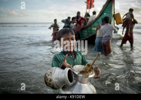 Teknaf, Bangladesh. 14th Sep, 2017. Myanmar Rohingya refugee boy with his family's few belongings, seen after arriving on a boat to Bangladesh on Shah Porir Dip Island. According to United Nations more than 400 thousand Rohingya refugees have fled Myanmar from violence over the last few weeks, most trying to cross the border and reach Bangladesh. International organizations have reported claims of human rights violations and summary executions allegedly carried out by the Myanmar army. Credit: K M Asad/zReportage.com/ZUMA Wire/Alamy Live News Stock Photo