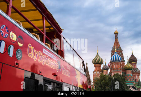 City SIghtseeing open top tour bus in Red Square near St Basil's Cathedral, Moscow, Russia.