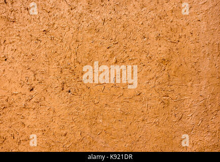Moroccan mud wall in ochre color as background. Stock Photo
