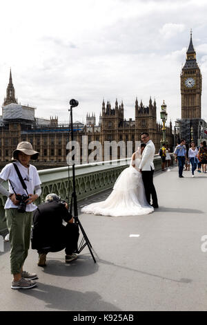 London, UK - August 14, 2017: Asian new married couple have their wedding photos taken in front of Westminster Palace Stock Photo