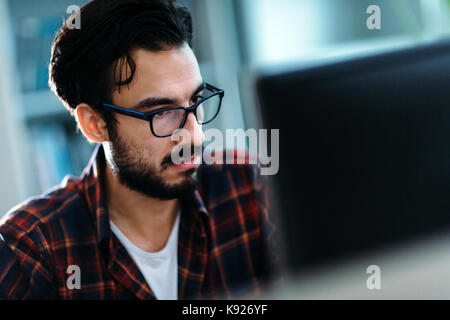Portrait of young programmer working in office Stock Photo