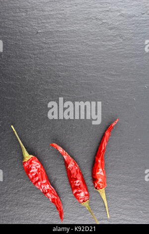 composition of dried thai chili peppers on a slate plate with copyspace Stock Photo