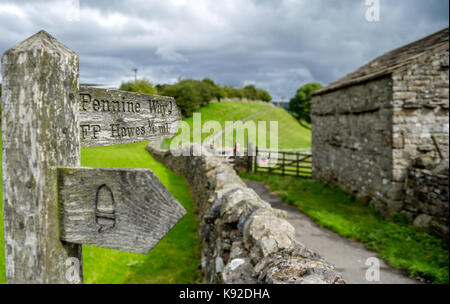 Sign for the Pennine Way mounted onto a wood post in a small Yorkshire maket town on Hawes. Stock Photo