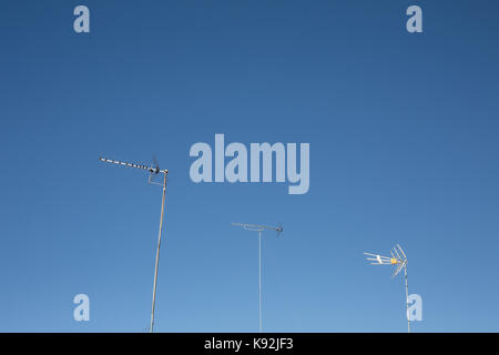 TV Aerial / Antenna masts against a blue sky. Stock Photo