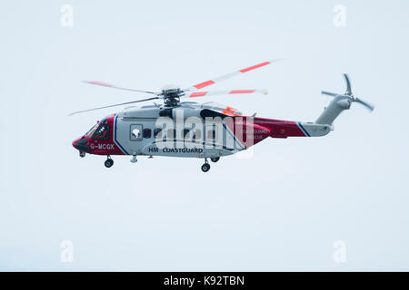 HM Coastguard search and rescue helicopter  G-MCGK  on patrol over the sea if Aberystwyth  Wales UK Stock Photo