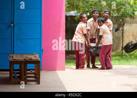 PONDICHERY, PUDUCHERY, INDIA - SEPTEMBER 04, 2017. Unidentified boys children bring the plate to be served at the outdoor canteen. Stock Photo