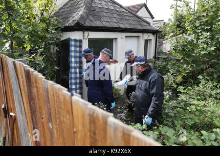 Police search the back of a property in Thornton Heath, south London, after a teenager was arrested by detectives investigating the Parsons Green terrorist attack, bringing the number of people being held to six. Stock Photo