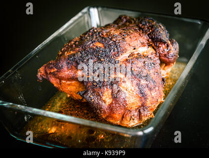 Pulled pork from oven, smoker or barbecue bbq in glass bowl ready for carving. Home made pulled pork made in house oven is ready to be pulled. Stock Photo