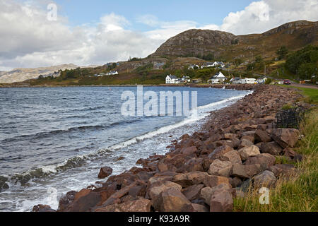 Looking north from Shieldaig across Loch Shieldaig showing rocky sea defences and shore line. Ross and Cromarty, Scotland Stock Photo