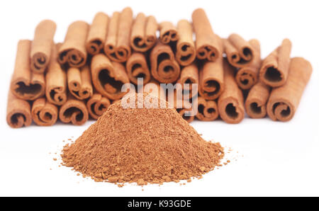 Some fresh aromatic cinnamon with powder spice over white background Stock Photo