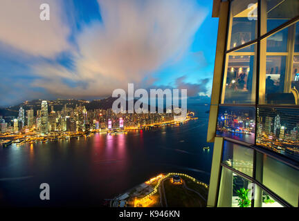 Aerial view of Hong Kong cityscape with illuminated skyscrapers at dusk. Stock Photo