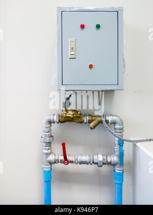 Electrical control box for water pumping in the public toilet of the small factory. Stock Photo