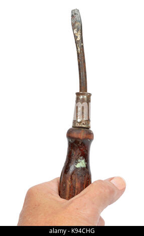 Vertical shot of an old hand holding an old bent screwdriver on a white background. Stock Photo