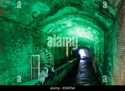 The River Aire passing under Leeds City train station, through an area known as the dark arches. Stock Photo