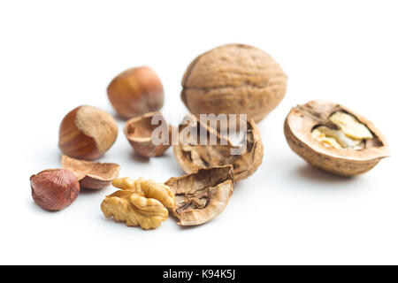 Cracked dried walnuts and hazelnuts isolated on white background. Tasty nuts. Stock Photo