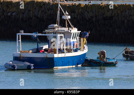 Fishermen on a fishing trawler in Folkstone harbour, Kent, UK Stock Photo