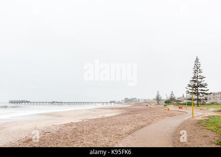 A beach scene, with the historic jetty in the back, in Swakopmund in the Namib Desert on the Atlantic Coast of Namibia Stock Photo