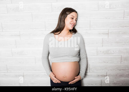 Pregnant woman in baby room Stock Photo