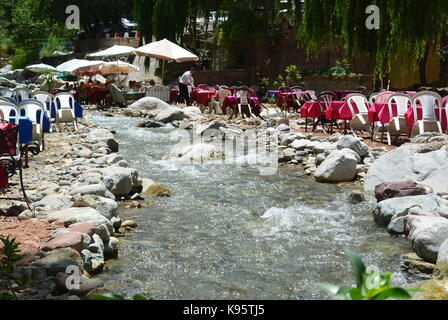 Tables at side of stream in hills near Marrakech Morocco Stock Photo