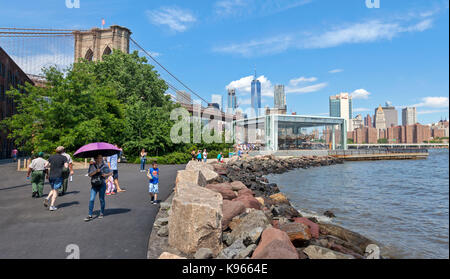 People walking, sitting and relaxing in the Brooklyn Bridge Park in Brookly, New York. Stock Photo