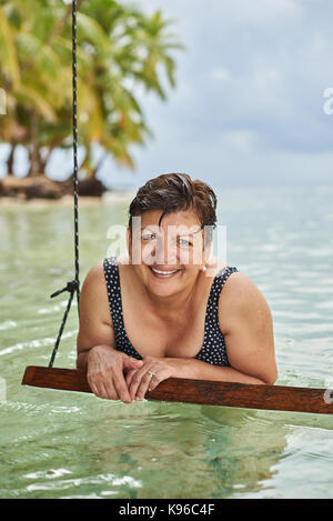 One smiling mature woman on sea beach Stock Photo